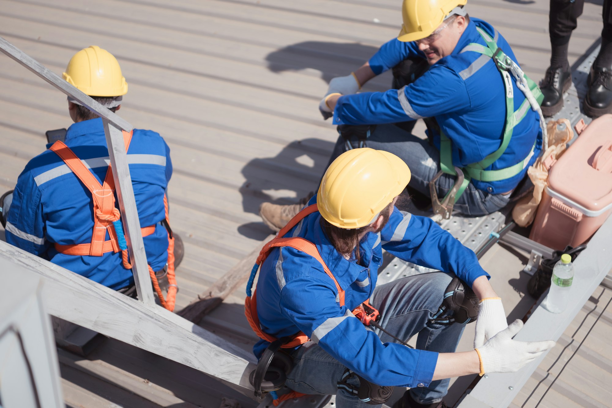 Workers on a construction site take a break on the roof of a building.